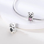 Dog Holding Pink Heart Charm