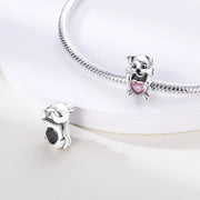Dog Holding Pink Heart Charm